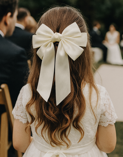 Beatrice Bow Barrette with a pink satin drawstring bag.