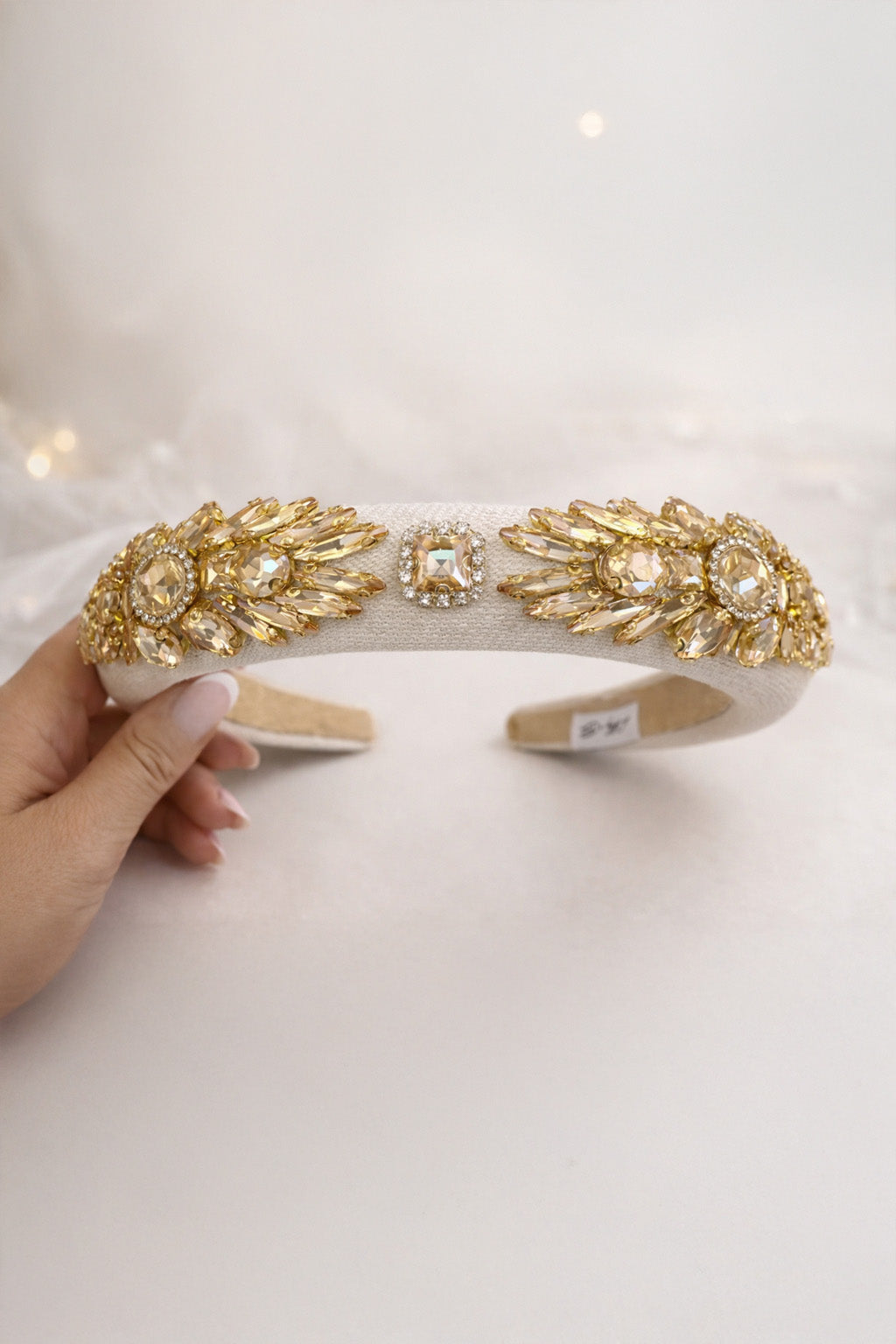 Delphine in Buttercream Headband (Ages 3-Adult) with a pink satin drawstring bag.