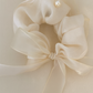 Dream Scrunchie with a pink satin drawstring bag.