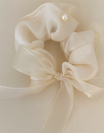 Dream Scrunchie with a pink satin drawstring bag.