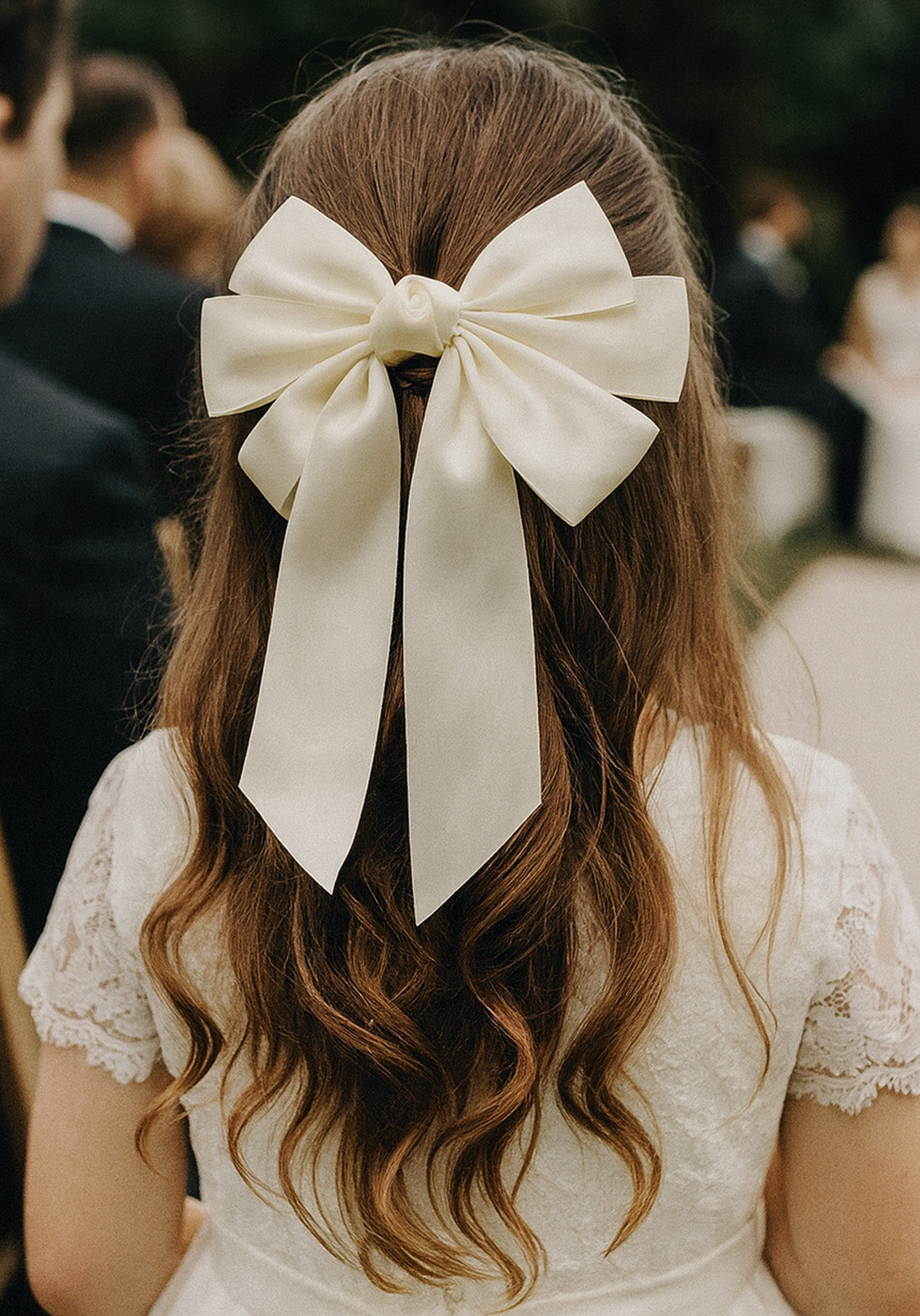 Beatrice Bow Barrette with a pink satin drawstring bag.