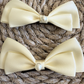 Caroline Cream Barrettes x 2 with a pink satin drawstring bag.