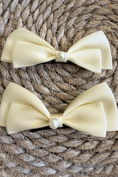 Caroline Cream Barrettes x 2 with a pink satin drawstring bag.