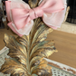 Sugar Rose Bow Barrette with a pink satin drawstring bag.