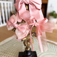 Sugar Rose Bow Barrette with a pink satin drawstring bag.