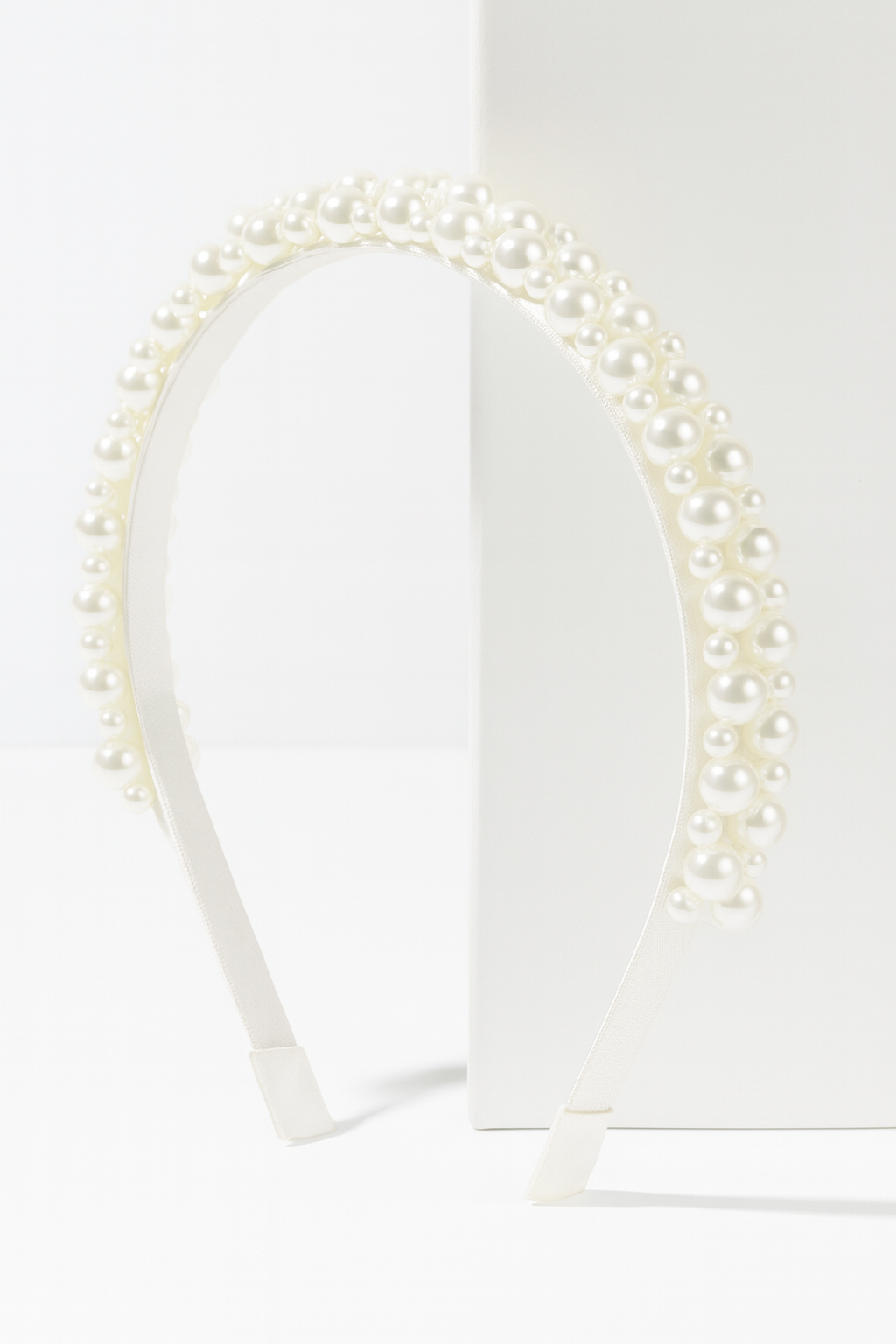 Poppy Pearls Headband (Ages 3 upwards) with a pink satin drawstring bag.
