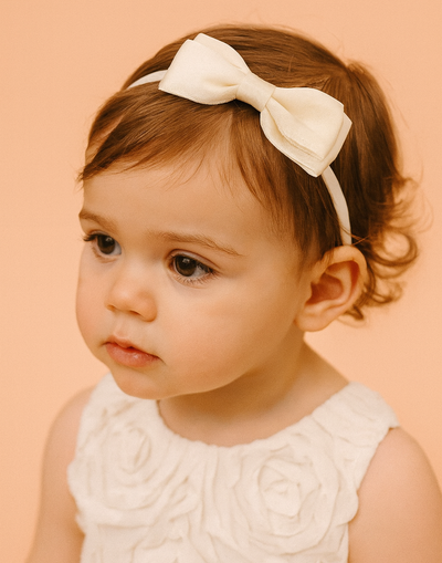Posie Cream Headband with a pink satin drawstring bag.