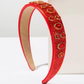 Red Sun Headband (Ages 6-Adult) with a pink satin drawstring bag.