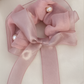 Rosie Scrunchie with a pink satin drawstring bag.
