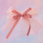 Strawberry Bow Barrette with a pink satin drawstring bag.