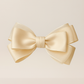 Sugar Cream Bow Barrette with a pink satin drawstring bag.